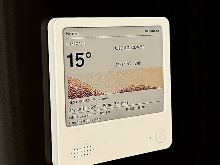 A small screen on a fridge door shows 15 degrees and a coloured weather chart.